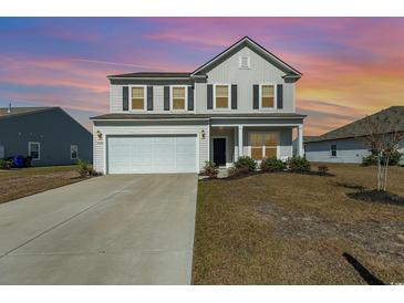 Two-story house with a white exterior and lawn at 3519 Cornflower Way, Conway, SC 29526