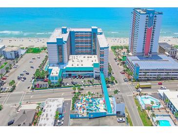 Aerial view of oceanfront resort with pool and parking at 1501 S Ocean Blvd. # 1038, Myrtle Beach, SC 29577
