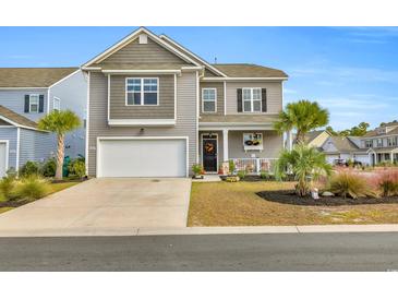 Two-story home with attached garage and charming front porch at 2000 Musgrove Mill Way, Myrtle Beach, SC 29579