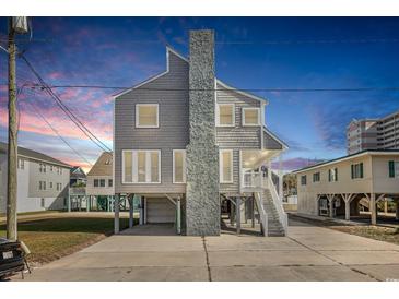 Elevated beach house with gray siding and two-car garage at 206 56Th Ave. N, North Myrtle Beach, SC 29582