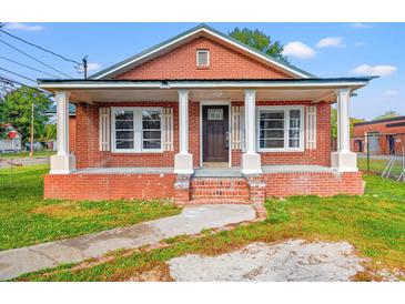 Brick home with front porch and landscaped yard at 1632 Butts St., Georgetown, SC 29440