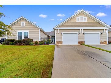 Tan two-story home with two-car garage and landscaped lawn at 1562 Palmina Loop # B, Myrtle Beach, SC 29588
