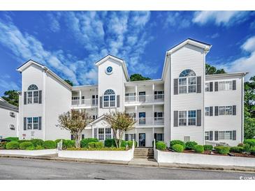 Three-story white building with balconies and landscaping at 1533 Lantern Rest Dr. # 201, Myrtle Beach, SC 29579