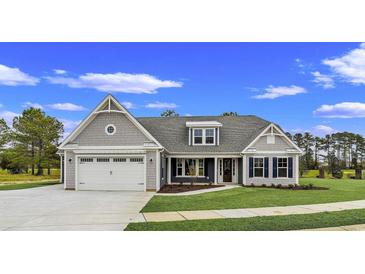 New two-story Craftsman style home with gray siding, gray roof and double garage at 550 Wagon Wheel Trail, Calabash, NC 28467