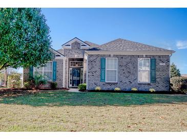 Brick house with teal shutters, landscaped lawn, and a spacious front yard at 296 Palmetto Glen Dr., Myrtle Beach, SC 29588