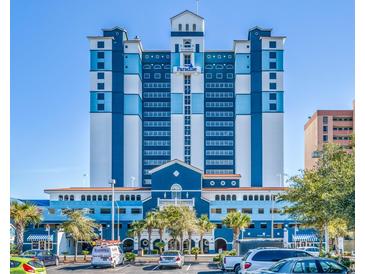 Paradise Resort: Oceanfront high-rise building with blue and white exterior and ample parking at 2201 S Ocean Blvd. # 1404, Myrtle Beach, SC 29577