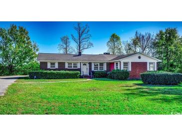 Brick ranch house with a well-maintained lawn at 3701 South Green Sea Rd., Loris, SC 29569