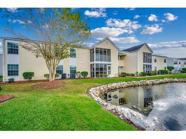 Building exterior with pond and landscaping at 2226 Huntington Dr. # D, Surfside Beach, SC 29575