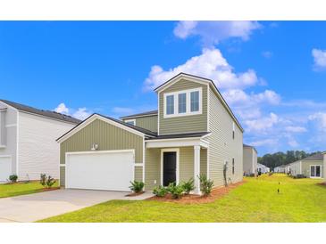 Two-story house with green siding and a white garage door at 420 Ribbon Rail Way, Loris, SC 29569
