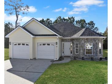 House exterior featuring a two-car garage and stone accents at 332 Sebastian Dr., Myrtle Beach, SC 29588