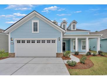 Two-story light blue house with a large gray garage door at 7274 Sarteano Dr., Myrtle Beach, SC 29572