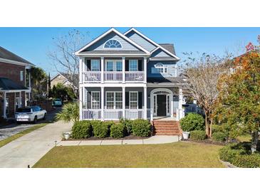 Two-story home with a wrap-around porch and manicured lawn at 879 Waterton Ave., Myrtle Beach, SC 29579