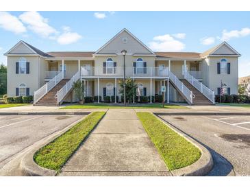 Tan three-story building with multiple units, stairs, and balconies at 111 Portsmith Dr. # 6, Myrtle Beach, SC 29588