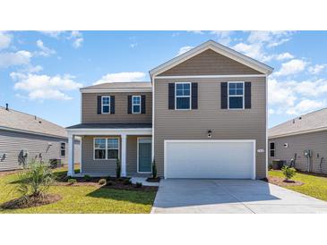 Two-story home with a two-car garage and landscaped lawn at 510 Firouz Dr, Longs, SC 29568