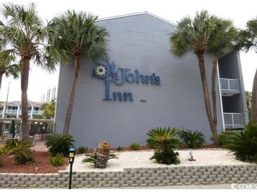 St. John's Inn exterior with palm trees and landscaping at 6803 N Ocean Blvd. # 217, Myrtle Beach, SC 29572