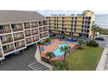 Aerial view of a beachfront condo complex with pool and parking at 202 75Th Ave N # 5702/5703, Myrtle Beach, SC 29572