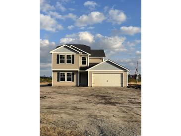 Two-story house with beige siding, gray accents, and a two-car garage at 819 Busy Corner Rd., Conway, SC 29527