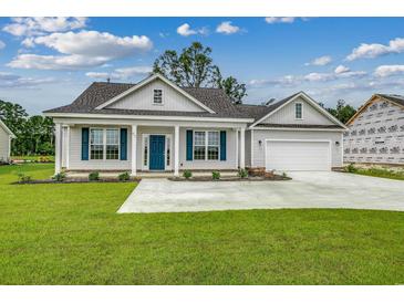 Charming one-story house with a two-car garage and landscaped lawn at 154 Six Mile Creek Dr., Georgetown, SC 29440