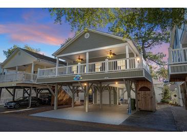 Elevated beach house with covered porch and parking underneath at 6001 - P-29 S Kings Hwy., Myrtle Beach, SC 29575