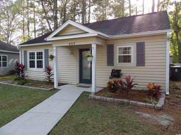 Inviting single-story home with landscaped yard and walkway at 6424 Spice Bush Crescent, Myrtle Beach, SC 29588