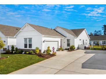 White house with gray roof, landscaping, and a two-car garage at 4036-D Taranto Loop # 5404-D, Myrtle Beach, SC 29579
