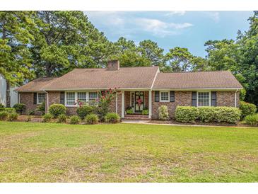 Brick ranch house with landscaped lawn and large front yard at 5000 Pine Lake Dr., Myrtle Beach, SC 29577