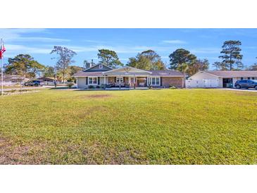 Charming single story home with a spacious front yard and well-maintained lawn at 1014 Thomas Ave., North Myrtle Beach, SC 29582