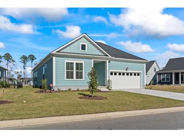 Craftsman style home with light blue siding, white trim, and a two-car garage at 2034 Comradery Way, Murrells Inlet, SC 29576