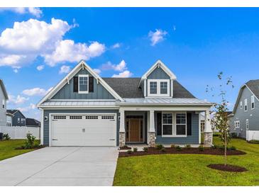 Two-story craftsman style home with gray siding, white trim, and a metal roof at 361 Starlit Way, Myrtle Beach, SC 29579