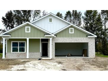 Two-story craftsman style home with green and white siding and a two-car garage at 534 War Eagle Ct., Conway, SC 29526