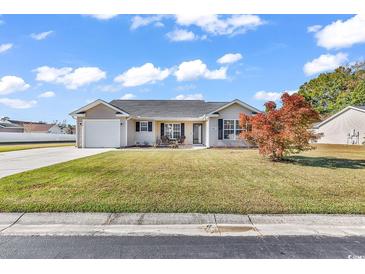 Nice curb appeal! This charming house features a well-maintained lawn and a two-car garage at 8417 Tartan Ln., Myrtle Beach, SC 29588