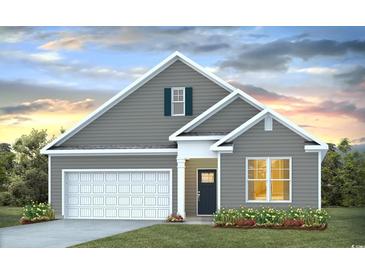 Gray house with white garage door and landscaping at 894 Farmers Passage Loop, Loris, SC 29569