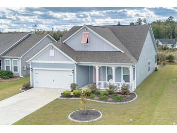 Gray siding house with white accents, landscaping, and a two-car garage at 208 Angel Wing Dr., Myrtle Beach, SC 29588