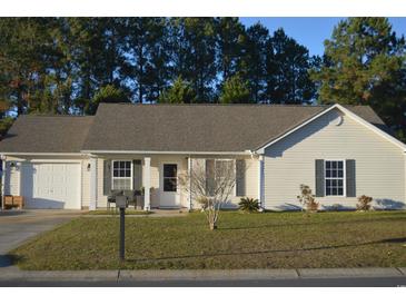 Ranch style home with attached garage and well-maintained lawn at 706 Wintercreeper Dr., Longs, SC 29568