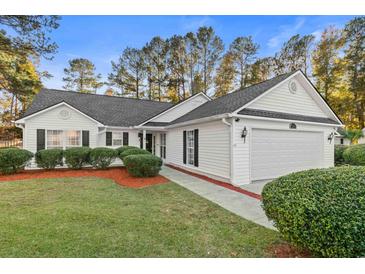 White house with gray roof, two-car garage, and landscaped lawn at 3604 Farmington Pl., Myrtle Beach, SC 29579