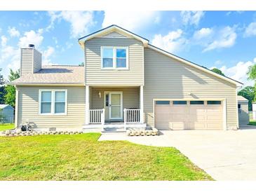 Beige two-story house with attached garage and landscaped lawn at 611 Six Lakes Dr., Myrtle Beach, SC 29588