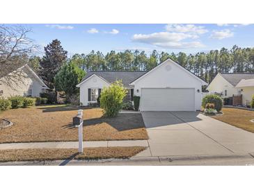 White house with a two-car garage and well-maintained lawn at 5027 Billy K Trail, Myrtle Beach, SC 29579