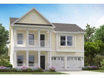 Charming two-story home with a balcony, garage, and landscaped yard at 731 Isle Verde Dr, Myrtle Beach, SC 29579