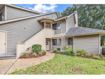 Gray siding condo with stairs leading to entrance, landscaping, and a grassy area at 101 Westhill Circle # 5-C, Myrtle Beach, SC 29572