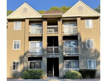 Three-story building with multiple balconies and parking at 100 G Myrtle Greens Dr. # G, Conway, SC 29526