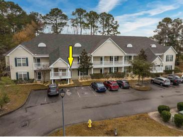 Attractive exterior of a two-story condo building with ample parking at 148 Scotch Broom Dr. # 102, Little River, SC 29566