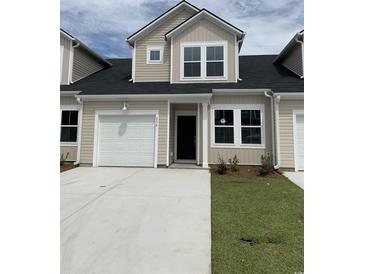 Two-story tan home with white garage door and landscaping at 178 Hoffman Park Dr. # 22, Myrtle Beach, SC 29588