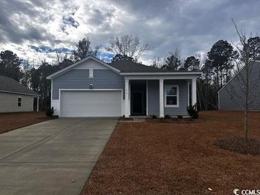 Newly constructed home with gray siding, two car garage, and front porch at 210 Linares St., Loris, SC 29569