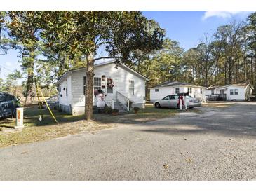 White house with yard, driveway, and nearby trees at 3055 Chestnut St., Loris, SC 29569
