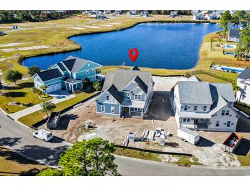 Aerial view of a new home with water views and nearby houses at 477 Starlit Way, Myrtle Beach, SC 29579