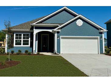 New blue home with white garage door and landscaped lawn at 534 Slaty Dr., Myrtle Beach, SC 29588