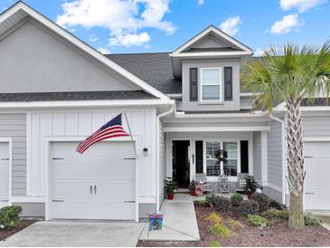 Gray two-story home with white garage door and welcoming front porch at 628 Lorenzo Dr. # 628, North Myrtle Beach, SC 29582