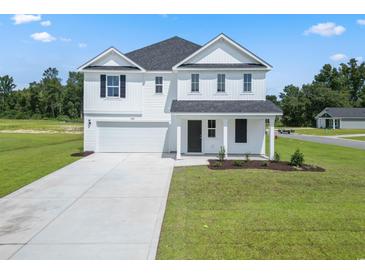 Two story home with white siding, gray roof, and a two car garage at 1040 Kinness Dr., Conway, SC 29527