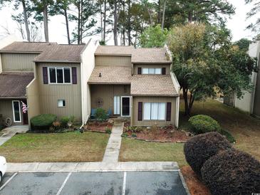 Attractive exterior of a two-story townhouse with landscaping and parking at 1100 Wedge Way # 72, Little River, SC 29566