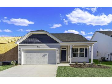 Newly constructed home with a white garage door and charming front porch at 1200 Nw Calabash Station Blvd., Calabash, NC 28467